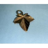 A 9 carat gold maple leaf broch, 2.5 gm; a cameo brooch in 9 carat gold mount
