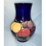 A Moorcroft baluster vase decorated in the wisteria pattern on a blue ground, signed and