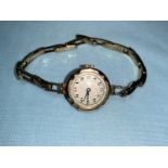 An early 20th century ladies gold wristwatch with gold strap (metal springs), 13.6 gm gross weight