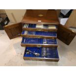 An EPNS canteen of cutlery for 12 place settings in oak 4 drawer box enclosed by twin locking doors