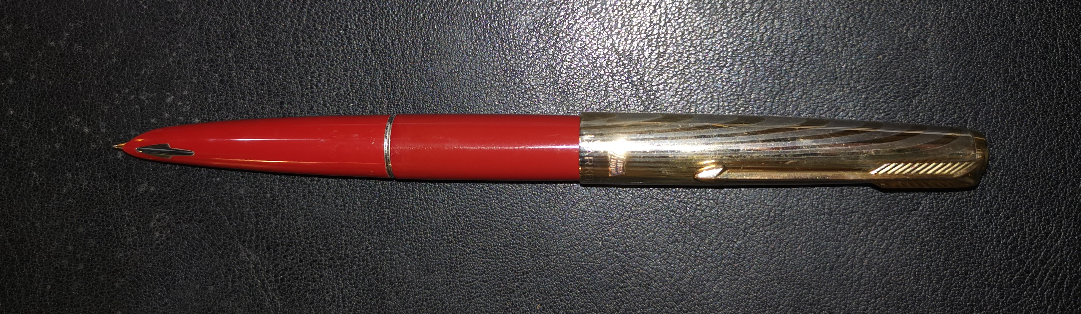 A Parker 61 red first edition fountain pen with gilt lid (a.f.)