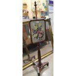 A 19th century mahogany pole screen with embroidered panel on reeded column and trefoil base