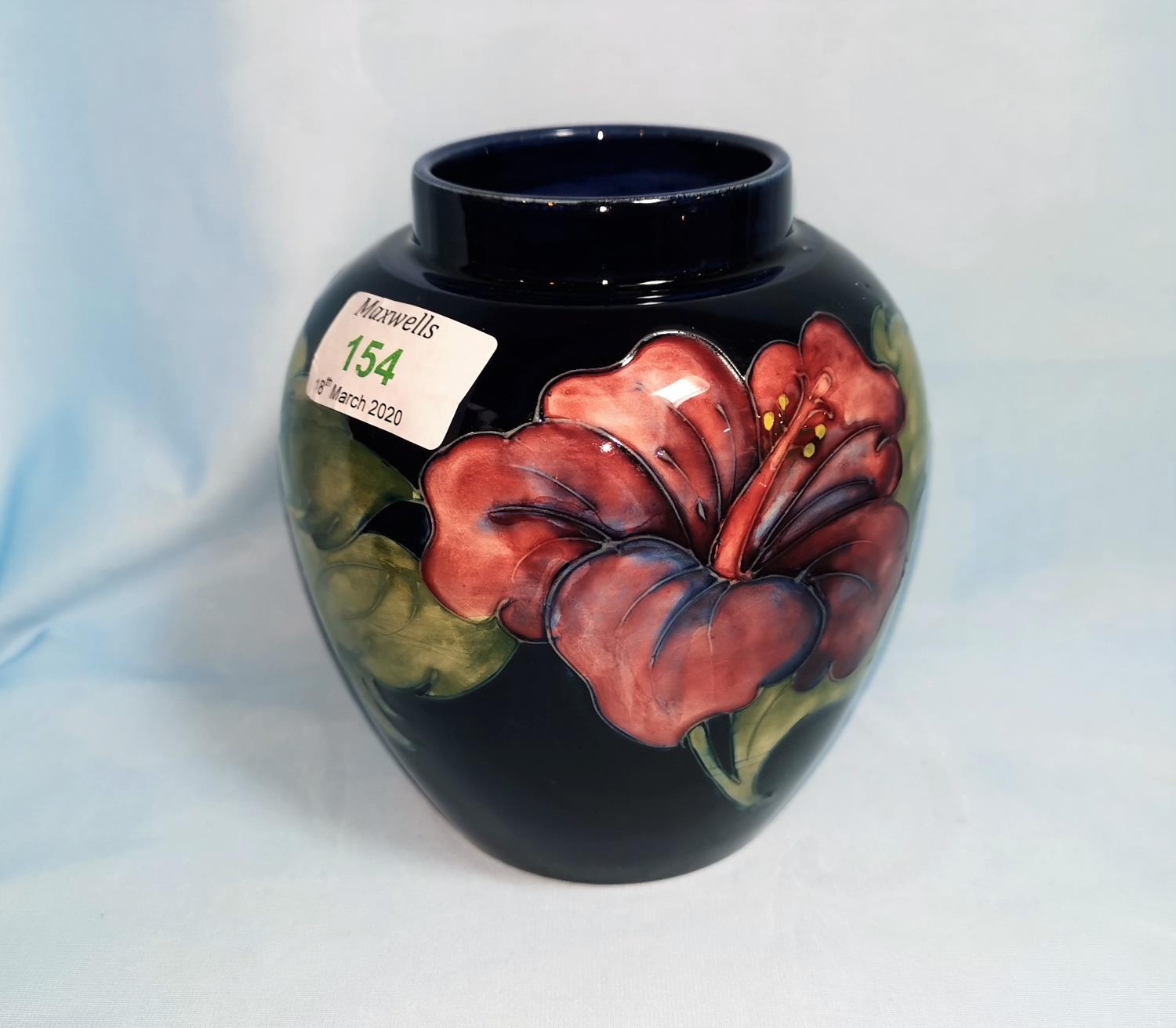 A Moorcroft ovoid vase decorated with tiger lilies on blue ground, 14 cm