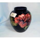 A Moorcroft ovoid vase decorated with tiger lilies on blue ground, 14 cm