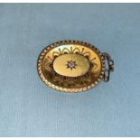 A Victorian gilt metal filigree brooch set with central old cut diamond with glass locket to the