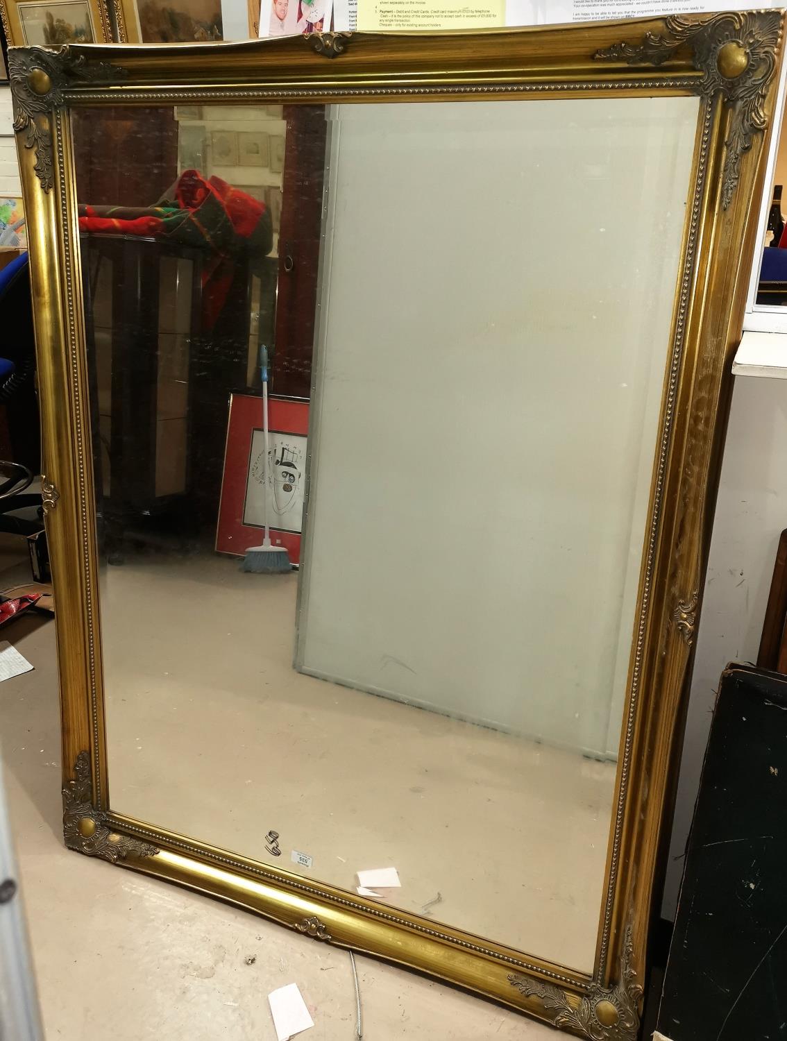 A large bevelled edge wall mirror in gilt frame