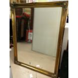 A large bevelled edge wall mirror in gilt frame