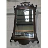 A 19th century bevelled wall mirror in Chippendale style fretwork frame