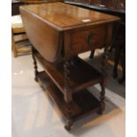 A 1930's oak 3 height drop leaf tea trolley on barley twist supports