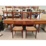 A 1960's teak Danish dining suite of 6 chairs with rail backs and raffia seats, bearing badge MK