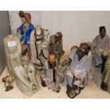 Seven Chinese stoneware figures of sages, sitting and standing, with crackle glaze robes and