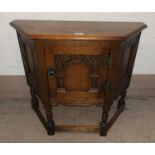 A canted oak reproduction hall cabinet; a drop leaf occasional table with oval swivel top