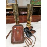 A pair of "Trench Art" embossed cartridge cases; a pair of French Hezzanith binoculars in leather c