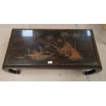 A Chinese carved hardwood coffee table with glass top