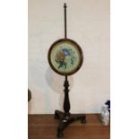 A Victorian rosewood pole screen with circular framed panel containing a contemporary watercolour of