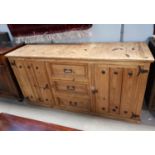 A rustic style sideboard of 2 cupboards and 3 drawers