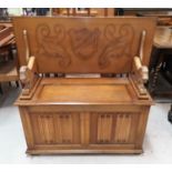 An oak reproduction monks bench with box seat