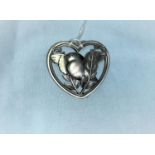 A Georg Jensen silver brooch designed by Arno Malinowski, model no,239, in heart-shaped rim, with