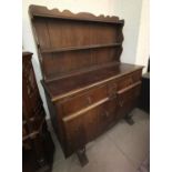 A 1930's oak sideboard of 2 cupboards and 2 drawers