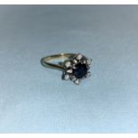 A dress ring set sapphire and diamonds, the shank marked '18 ct'