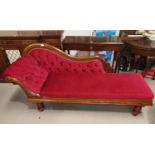 A Victorian mahogany scroll back chaise longue on turned legs and castors, wine dralon