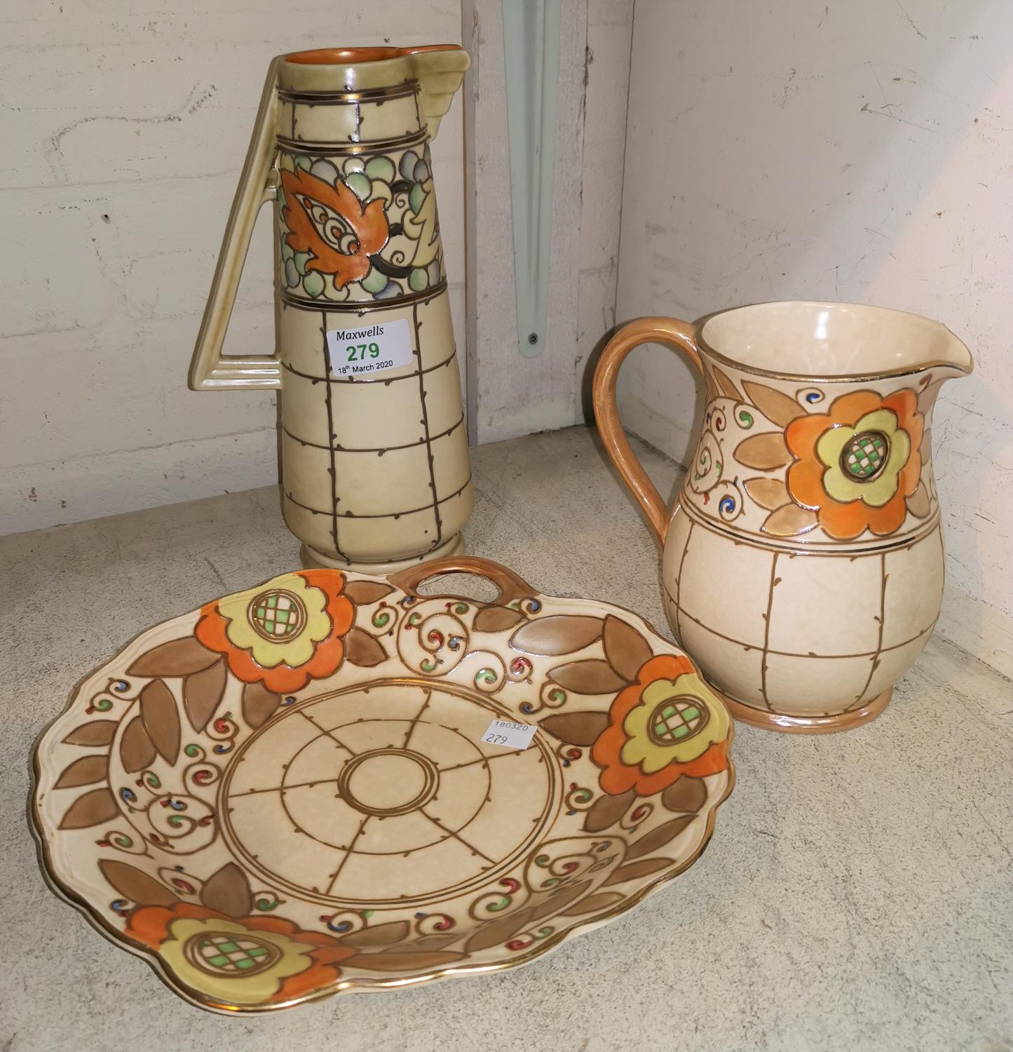 Two Charlotte Rhead tube lined jugs heights 25cm and 16cm and a shallow dish length 25cm