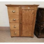 A continental stripped pine side cabinet with single cupboard and 4 drawers