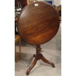 An oak and mahogany circular pedestal