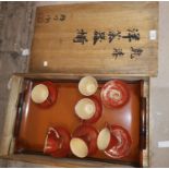 An oriental large lacquer work rectangular tray decorated with a setting sun and leaves, paper label