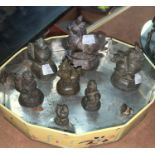 A 19th century Burmese set of 9 graduating bronze opium weights in the form of mythical beasts