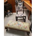 A 19t century high back rocking chair in chintz fabric; a long low footstool with needlework seat