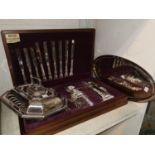 A walnut cased canteen of cutlery; an entrée dish and tray; a dressing table set
