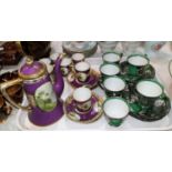 A Noritake 15 piece coffee set in purple and gilt with hand painted landscape vignettes; a
