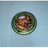 A miniature compact in green enamel, the lid with polychrome 18th century lovers in a bower