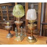 Three brass oil lamps, 2 with shade; a brass fender; miscellaneous old bottles; 2 vintage tennis