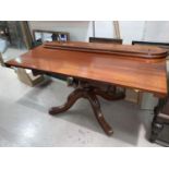 A Victorian mahogany dining/side table with small detachable side leaf on four foot pedestal base