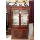A Regency style inlaid mahogany full height display cabinet by Dickinson's of Ipswich, with 2