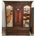 An Edwardian carved walnut wardrobe with 2 mirror doors and base drawer