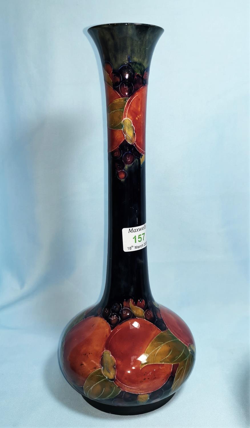 A Moorcroft pottery pomegranate vase of bulbous form with tall neck with everted rim, 33 cm