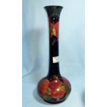A Moorcroft pottery pomegranate vase of bulbous form with tall neck with everted rim, 33 cm