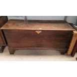 An 18th century oak blanket box with hinged lid, on bracket feet