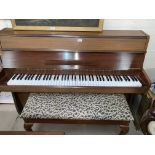 A neat modern sapele teak cased iron framed over strung piano by Heinz Kuhn, with duet stool
