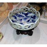 A Chinese blue & white porcelain bowl decorated with bats, pierced latticework border, carved
