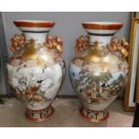 A 19th century Japanese pair of imposing temple urns of baluster form, Kutani porcelain with red