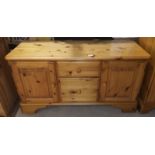 A Ducal pine side cabinet, fitted drawers and cupboards, 110 cm