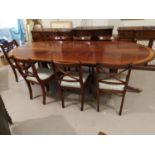 A Regency style inlaid mahogany dining suite by Dickinson's of Ipswich, comprising twin pedestal
