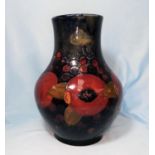 a 1930'S Moorcroft baluster vase decorated in the pomegranate pattern against a blue ground,