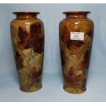 A late 19th century pair of Royal Doulton tapering vases decorated with autumn leaves, impressed