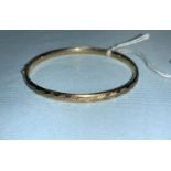 A yellow metal bangle stamped 9kt, 375, 6gm
