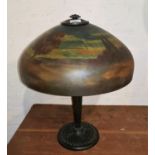 An Art Deco bronze table lamp with hand painted glass landscape shade, height 57cm